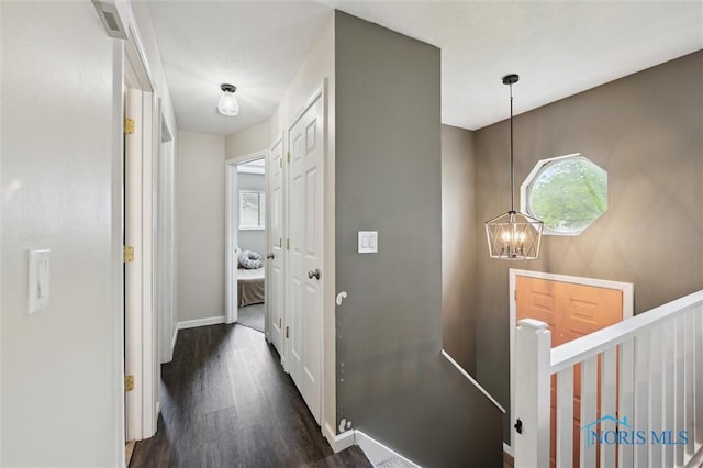 513 Bay River Ct, Maumee, OH 43537 - corridor with an upstairs landing, dark wood finished floors, a chandelier, and baseboards
