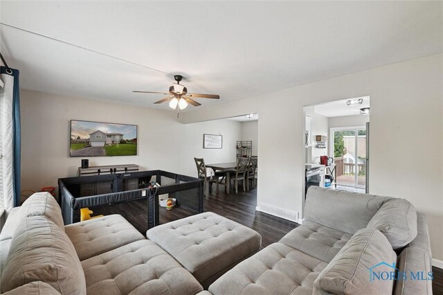 513 Bay River Ct, Maumee, OH 43537 - living area with dark wood-style flooring, a ceiling fan, and baseboards