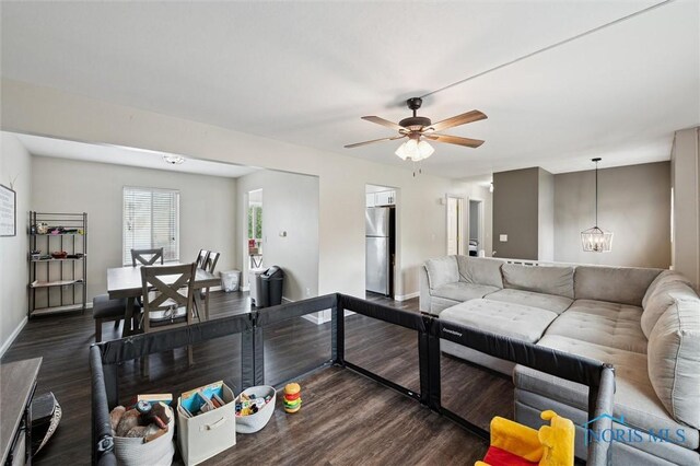 513 Bay River Ct, Maumee, OH 43537 - living area featuring baseboards, a chandelier, wood finished floors, and ceiling fan