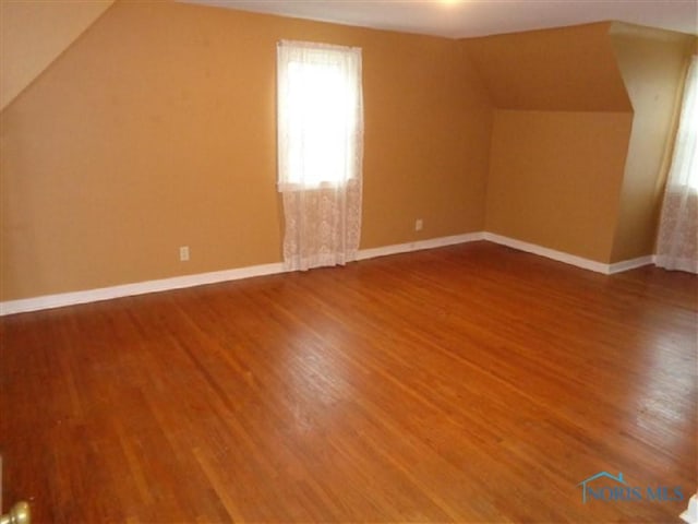 934 E 4th St, Ottawa, OH 45875 - bonus room featuring vaulted ceiling, wood finished floors, and baseboards
