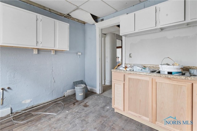 128 W Bancroft St, Toledo, OH 43620 - kitchen with light countertops, light brown cabinetry, white cabinets, and baseboards