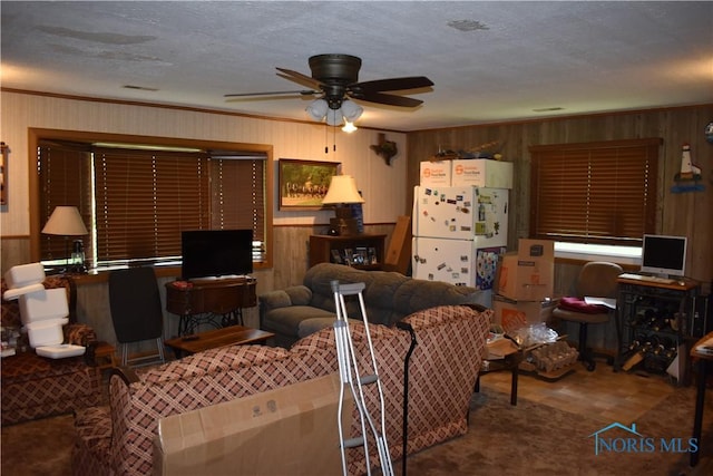 4260 S Eber Rd, Monclova, OH 43542 - living area with a ceiling fan, wood walls, a textured ceiling, and ornamental molding