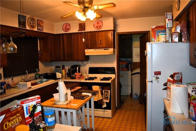 4260 S Eber Rd, Monclova, OH 43542 - kitchen featuring range with gas stovetop, under cabinet range hood, freestanding refrigerator, ceiling fan, and light countertops