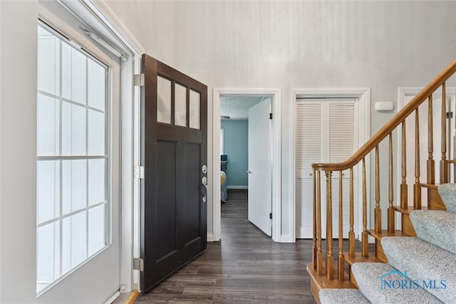 21265 State Route 2, Archbold, OH 43502 - foyer entrance featuring stairs, dark wood finished floors, a towering ceiling, and baseboards