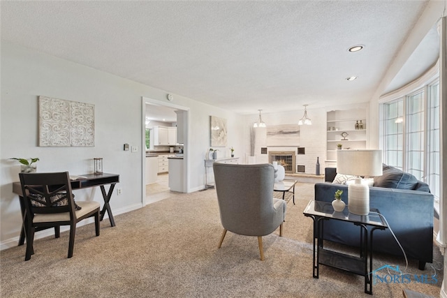 21265 State Route 2, Archbold, OH 43502 - living room with light carpet, a textured ceiling, a glass covered fireplace, baseboards, and recessed lighting