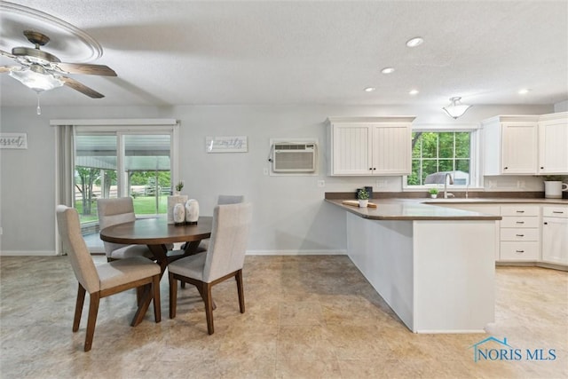 21265 State Route 2, Archbold, OH 43502 - dining space featuring a wall mounted AC, baseboards, recessed lighting, a ceiling fan, and a textured ceiling