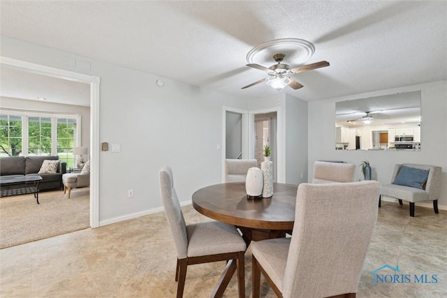 21265 State Route 2, Archbold, OH 43502 - dining area featuring ceiling fan, a textured ceiling, and baseboards