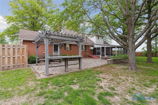 21265 State Route 2, Archbold, OH 43502 - back of house featuring a pergola, a sunroom, brick siding, and a patio