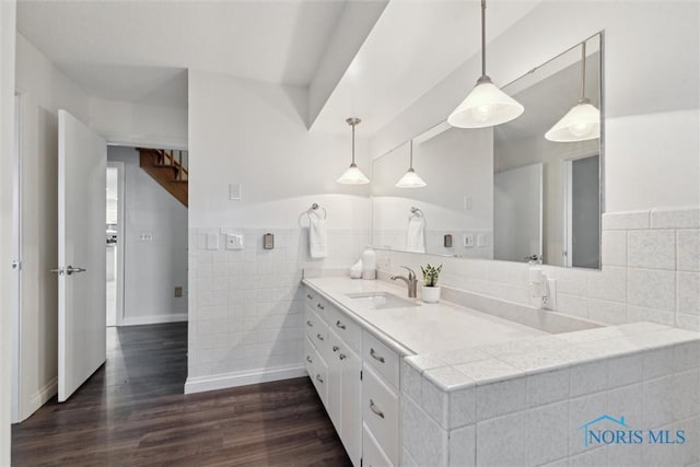 21265 State Route 2, Archbold, OH 43502 - bathroom with double vanity, wood finished floors, and tile walls
