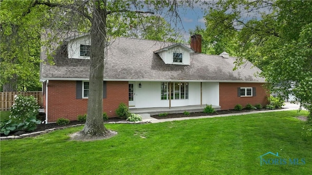 21265 State Route 2, Archbold, OH 43502 - cape cod house with a chimney, brick siding, and roof with shingles