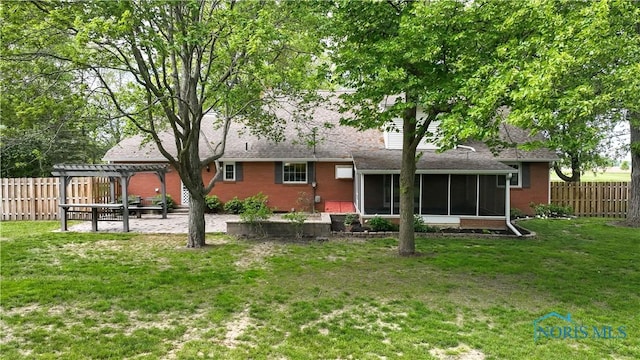 21265 State Route 2, Archbold, OH 43502 - back of house featuring a pergola, a sunroom, brick siding, and a patio