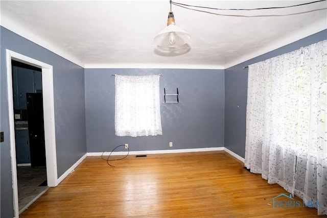 1702 E Hopkins St, Defiance, OH 43512 - spare room with wood finished floors and baseboards