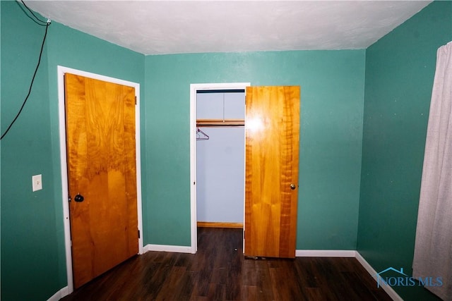 1702 E Hopkins St, Defiance, OH 43512 - unfurnished bedroom with wood finished floors, baseboards, and a closet