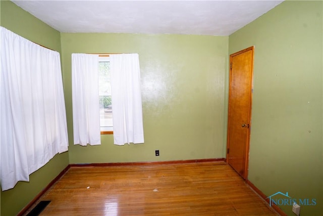 1702 E Hopkins St, Defiance, OH 43512 - spare room with hardwood / wood-style flooring and baseboards