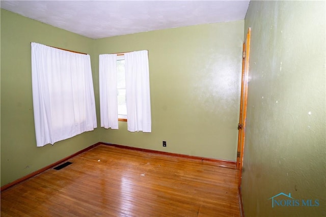 1702 E Hopkins St, Defiance, OH 43512 - spare room with hardwood / wood-style floors and baseboards
