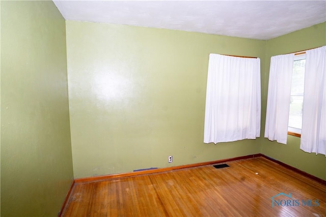 1702 E Hopkins St, Defiance, OH 43512 - spare room featuring wood finished floors and baseboards