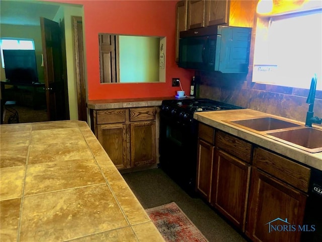 5151 Keller Rd, Walbridge, OH 43465 - kitchen featuring black appliances, a sink, and tasteful backsplash