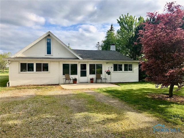 5151 Keller Rd, Walbridge, OH 43465 - back of house featuring a patio, a chimney, and a lawn