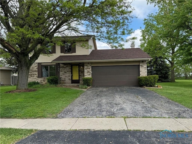 2717 Coveview Dr, Toledo, OH 43611 - view of front of property featuring driveway, a garage, brick siding, a front yard, and a chimney