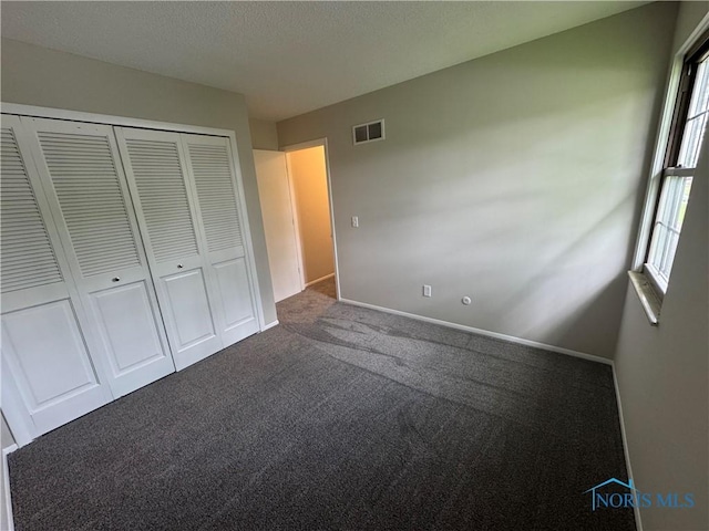 2717 Coveview Dr, Toledo, OH 43611 - unfurnished bedroom with carpet, a closet, baseboards, and a textured ceiling