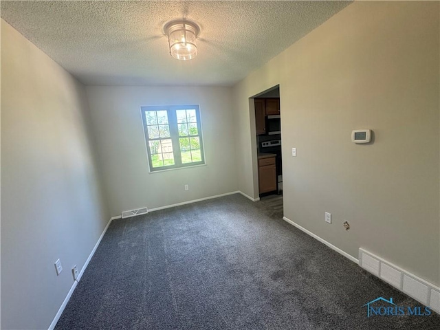 2717 Coveview Dr, Toledo, OH 43611 - unfurnished room featuring dark carpet, a textured ceiling, and baseboards
