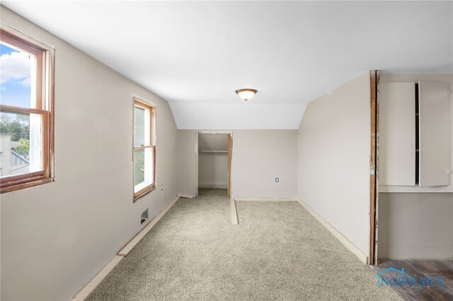 4927 N Summit St, Toledo, OH 43611 - unfurnished bedroom with lofted ceiling, carpet flooring, and baseboards