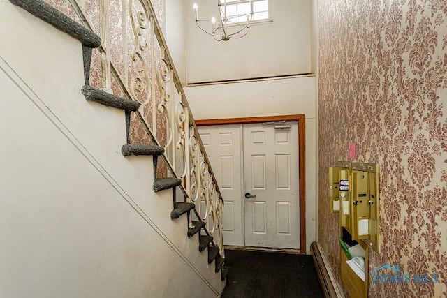 2340 Torrey Hill Dr, Toledo, OH 43606 - entrance foyer with stairway and a chandelier
