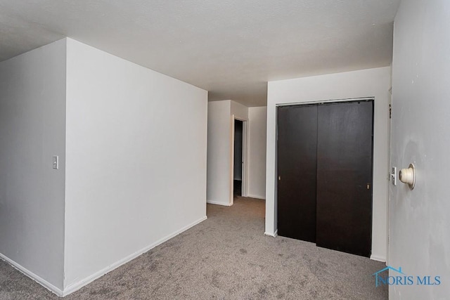 2340 Torrey Hill Dr, Toledo, OH 43606 - unfurnished bedroom featuring carpet, a closet, and baseboards