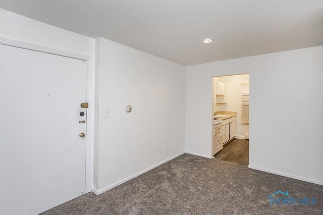 2340 Torrey Hill Dr, Toledo, OH 43606 - unfurnished bedroom with dark colored carpet and baseboards