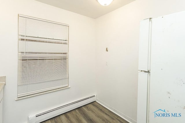 2340 Torrey Hill Dr, Toledo, OH 43606 - unfurnished room with a baseboard heating unit, dark wood-style flooring, and baseboards