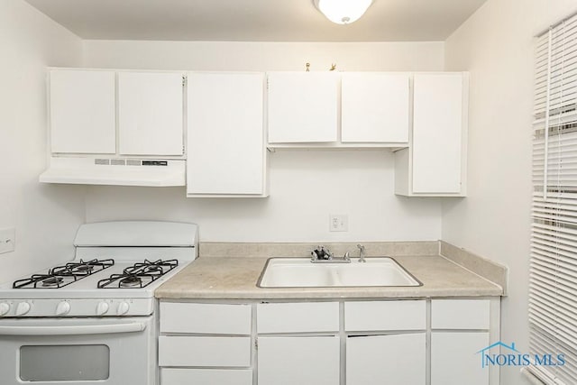 2340 Torrey Hill Dr, Toledo, OH 43606 - kitchen featuring white gas range oven, under cabinet range hood, a sink, white cabinetry, and light countertops