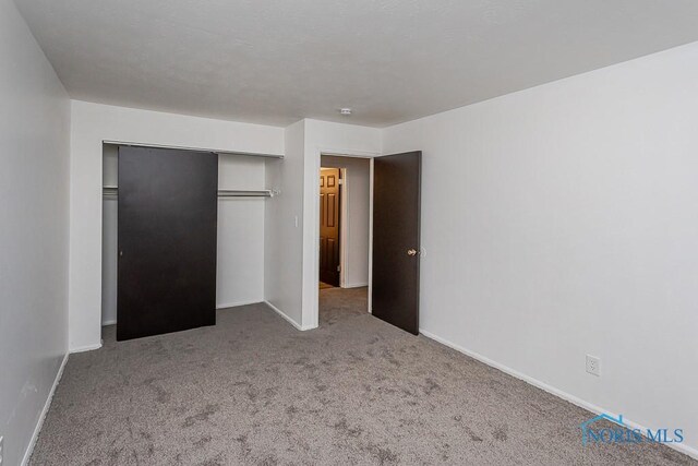 2340 Torrey Hill Dr, Toledo, OH 43606 - unfurnished bedroom with carpet, baseboards, and a closet