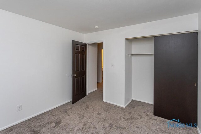 2340 Torrey Hill Dr, Toledo, OH 43606 - unfurnished bedroom with carpet, baseboards, and a closet