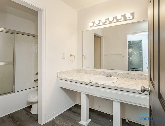 2340 Torrey Hill Dr, Toledo, OH 43606 - full bathroom with wood finished floors, toilet, combined bath / shower with glass door, and vanity