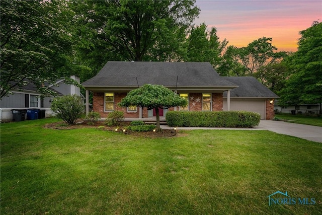 1956 Thornapple Dr, Toledo, OH 43614 - view of front facade with driveway, a garage, a yard, and brick siding