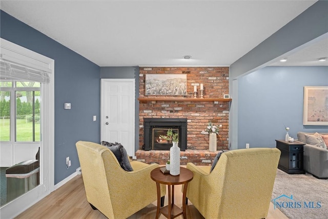 1956 Thornapple Dr, Toledo, OH 43614 - living room with a fireplace, wood finished floors, and baseboards