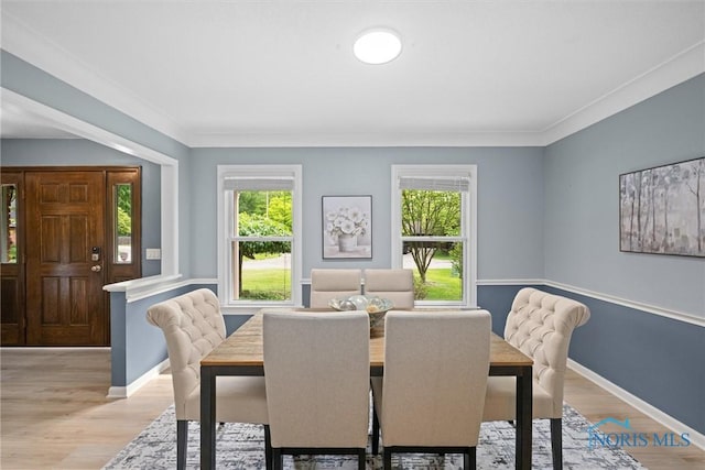 1956 Thornapple Dr, Toledo, OH 43614 - dining room with healthy amount of natural light, light wood finished floors, baseboards, and ornamental molding