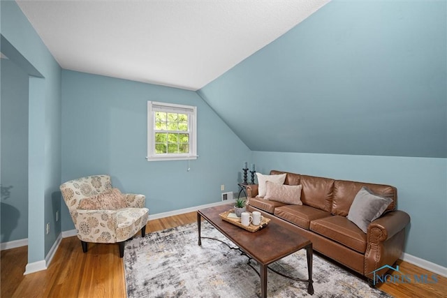 1956 Thornapple Dr, Toledo, OH 43614 - living room featuring lofted ceiling, wood finished floors, and baseboards