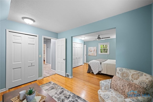 1956 Thornapple Dr, Toledo, OH 43614 - bedroom featuring two closets, light wood-type flooring, baseboards, and ceiling fan