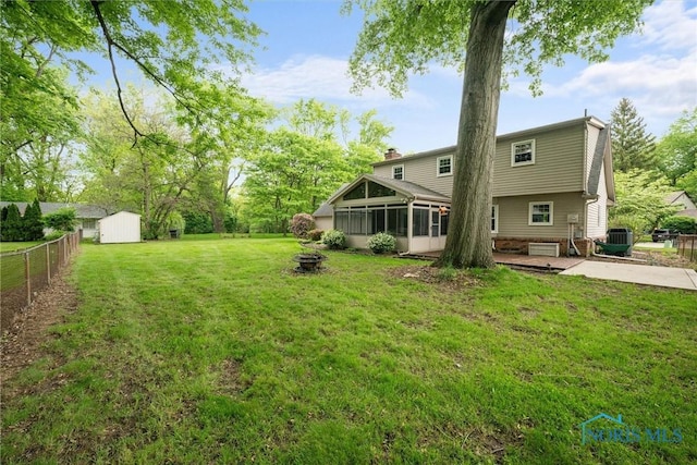 1956 Thornapple Dr, Toledo, OH 43614 - view of yard with a patio area, a sunroom, an outdoor fire pit, and central AC