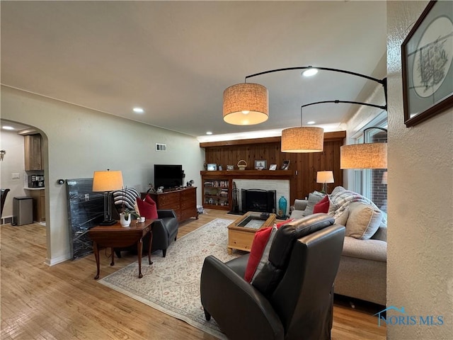 1226 Champe Rd, Toledo, OH 43615 - living area with arched walkways, wood finished floors, recessed lighting, and a fireplace