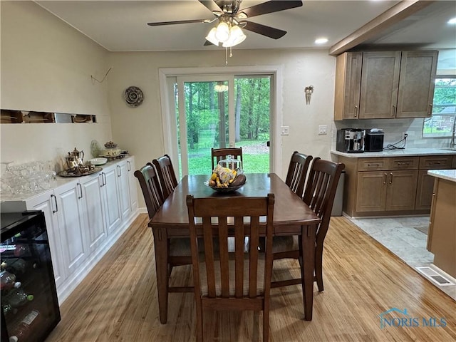 1226 Champe Rd, Toledo, OH 43615 - dining area with ceiling fan, light wood-style floors, and beverage cooler