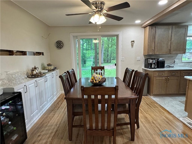 1226 Champe Rd, Toledo, OH 43615 - dining space featuring wine cooler, light wood-style floors, a ceiling fan, and recessed lighting