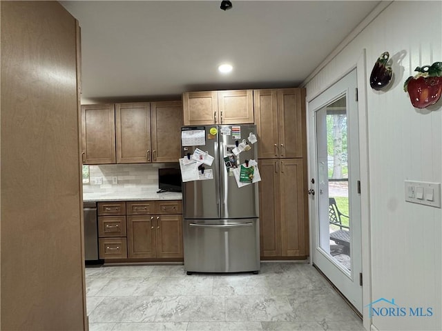 1226 Champe Rd, Toledo, OH 43615 - kitchen featuring appliances with stainless steel finishes, backsplash, and light countertops