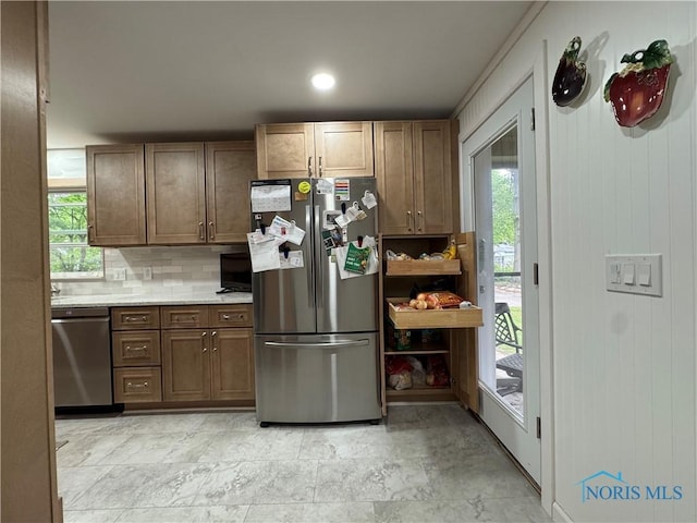 1226 Champe Rd, Toledo, OH 43615 - kitchen with appliances with stainless steel finishes, decorative backsplash, and healthy amount of natural light
