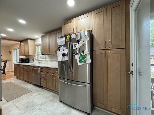 1226 Champe Rd, Toledo, OH 43615 - kitchen with stainless steel appliances, recessed lighting, a sink, backsplash, and light countertops