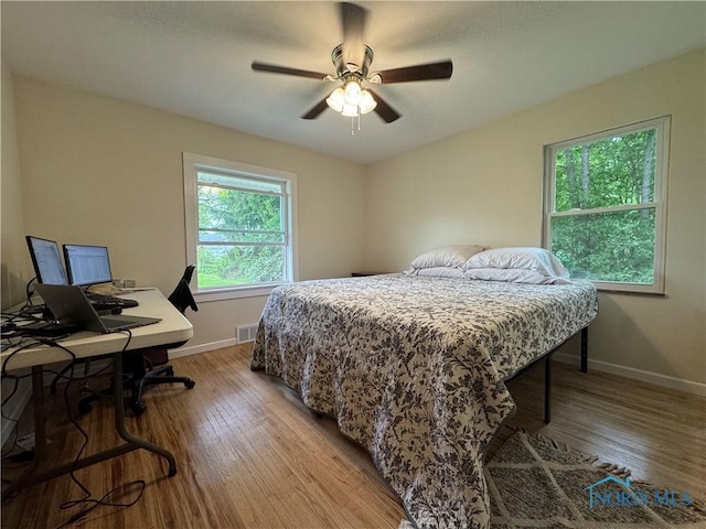 1226 Champe Rd, Toledo, OH 43615 - bedroom featuring wood finished floors, baseboards, a ceiling fan, and a desk