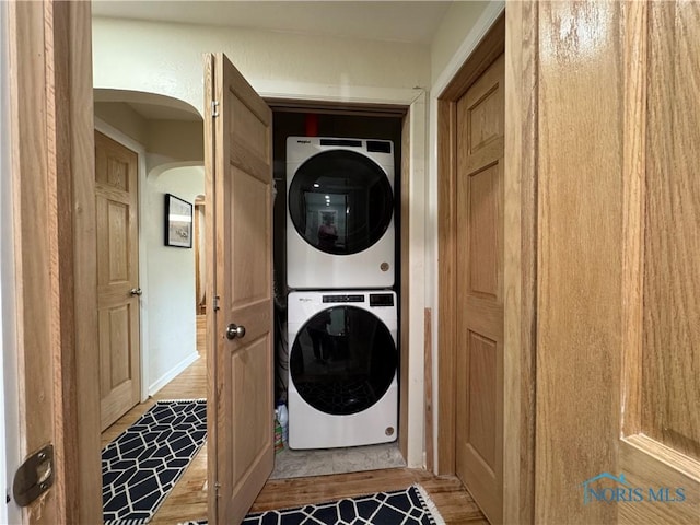 1226 Champe Rd, Toledo, OH 43615 - laundry area featuring stacked washer / drying machine, wood finished floors, and arched walkways