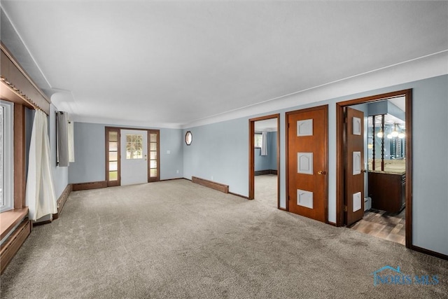 503 Church St, Helena, OH 43435 - unfurnished room featuring carpet, baseboards, and a baseboard heating unit