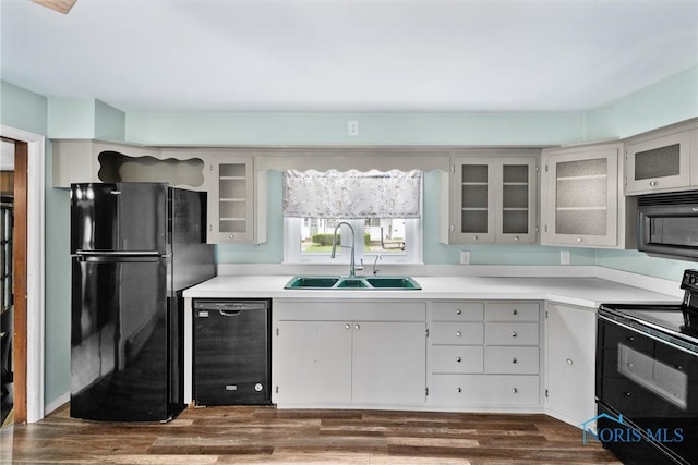 503 Church St, Helena, OH 43435 - kitchen with black appliances, a sink, light countertops, and dark wood-style flooring